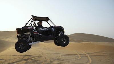 Ricky Wilson rides the desert dunes. Courtesy Etihad Airways