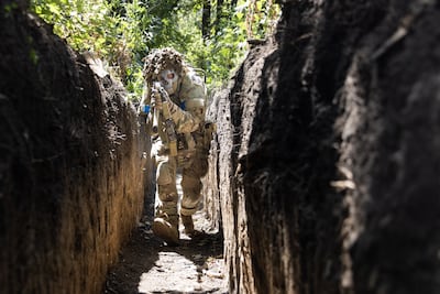 LUHANSK, UKRAINE - JULY 05: A soldier demonstrates tactical movements inside a trench with the 110th Brigade, a Territorial Defense unit, in Novodarivka settlement, Luhansk Oblast, Ukraine on July 05, 2023. The Ukraine Armed Forces launched their counteroffensive in June, and has been making slow gains, often counted in meters, to liberate areas previously captured by Russian troops. (Photo by Daniel Carde/Anadolu Agency via Getty Images)
