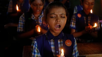 Indian students pray for the Thai boys. Ajit Solanki / AP