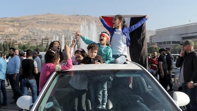 Syrian children wave a national flag during the gathering in Umayyad square. Youssef Badawi / EPA