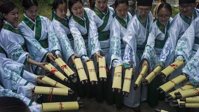 University students celebrate with their certificates during a graduation ceremony at the campus of Hebei Academy of Fine Arts in Xinle, Hebei province. A Chinese university has earned comparisons with Harry Potter’s Hogwarts due to its bizarre castle campus. Fred Dufour / AFP