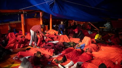 Migrants rest inside a rescue vessel at the port of Algeciras, southern Spain, after being rescued in the Strait of Gibraltar. AP