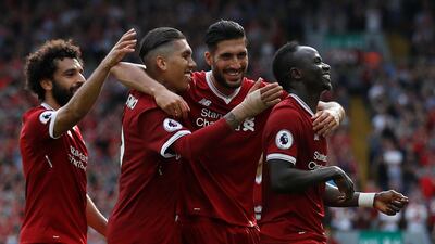 Liverpool's Mohamed Salah, left, Roberto Firmino, centre left, and Sadio Mane, right, were all on the score sheet against Arsenal. Carl Recine / Reuters