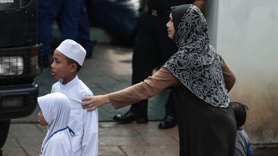 A relative of a teenage student cries after a fire broke out at a religious school in Jalan Datuk Keramat, Kuala Lumpur, Malaysia. Fazry Ismail / EPA