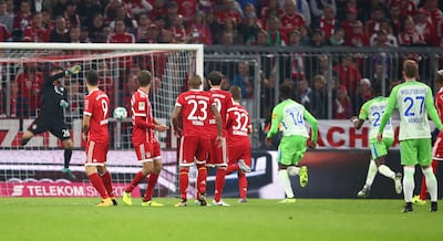 Bayern Munich goalkeeper Sven Ulreich, left, produced a costly mistake from this free-kick on Saturday. Michael Dalder / Reuters
