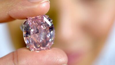 A Sotheby's employee shows The Pink Star diamond weighing 59.6 carat. The Pink Star, one of the world's natural treasures, is the most valuable diamond ever to be offered at auction. AP Photo / Keystone, Martial Trezzini