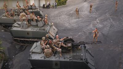 Lebanese soldiers take up position in Khalde, south of Beirut, after a gun attack on a Hezbollah funeral.