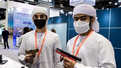 Omar Al Matrooshi and Rashed Al Raess hold 9mm pistols made by Austrian manufacturer Glock. About 800 international companies are attending Idex 2021. Victor Besa / The National