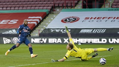 Arsenal's Alexandre Lacazette scores to open the scoring agaimnst Sheffield goalkeeper Aaron Ramsdale. EPA
