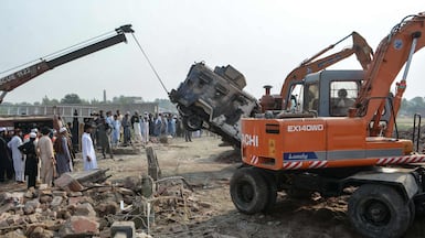 A burnt-out armoured vehicle is removed from a damaged police checkpoint after a militant car bombing in Bannu, Pakistan. At least a dozen were killed. AFP