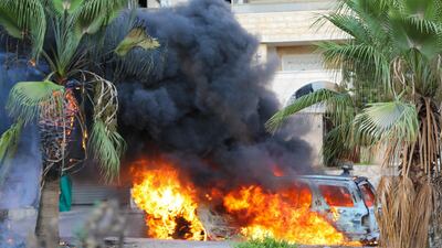 Flames engulf a vehicle following clashes in the Khalde area, south of the Lebanese capital.