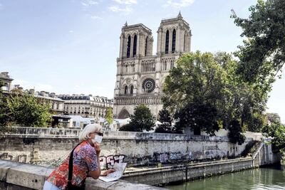 A tourist stands in front of Notre-Dame cathedral in Paris in September. AFP