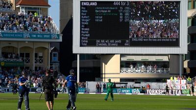 England batsmen Eoin Morgan, left, and Jos Buttler leave the field after their 50-over record innings of 444 on Tuesday. Stu Forster / Getty Images / August 30, 2016