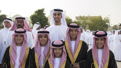 Sheikh Khaled bin Zayed, Chairman of the Board of Zayed Higher Organisation for Humanitarian Care and Special Needs, back centre, with young guests at the group wedding. Mohamed Al Raeesi for Crown Prince Court - Abu Dhabi