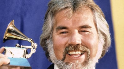 Kenny Rogers receives Grammy Award in 1980. His classic track 'The Gambler' has been inducted into the 2021 Grammy Hall of Fame. MPTV Images.
