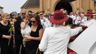 Melissa and Charlotte O'Dwyer, the wife and young daughter of Rural Fire Service volunteer Andrew O'Dwyer, farewell their husband and father during the funeral at Our Lady of Victories Catholic Church in Horsley Park, Sydney. Getty Images