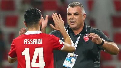 Al Ahli coach Cosmin Olaroiu celebrates with Oussama Assaidi after the team's advancement to the Asian Champions League final. Marwan Naamani / AFP / October 20, 2015