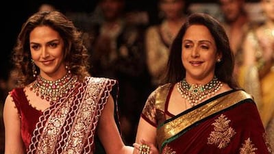 Bollywood actress Hema Malini, right, and her daughter Esha Deol display creations by designers Shyamal and Bhumika.