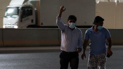 Abey Poulose collects the ball from the road outside Sharjah Cricket Stadium.