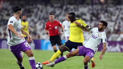 Sadio Mane of Al Nassr and Al Ain's Yahya Ben Khaleq battle for the ball. Chris Whiteoak / The National