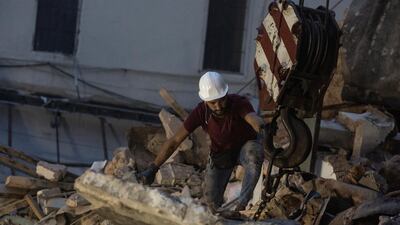 A rescue worker chains concrete to a crane while trying to find a survivor of the Beirut blast in Beirut, Lebanon. A sniffer dog with a Chilean rescue crew responded to the presence of a person in the rubble of a building damaged in the deadly explosion on August 4. The condition of the person is unknown. Getty Images