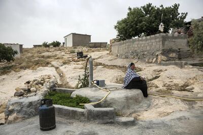 Amina Dababsee, 67, has a solar-powered pump to draw water from her well in Khallet ad-Daba'a village in the isolated South Hebron hills of the West Bank. Heidi Levine for The National