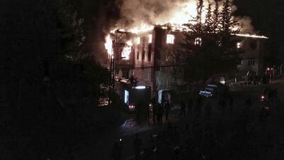 Flames rise from a fire in a school dormitory, in Aladag, Adana in southern Turkey. DHA via AP