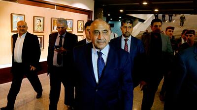 Iraq's new Prime Minister Adel Abdul Mahdi, center, leaves the parliament building in Baghdad, Iraq, Tuesday, Oct. 2, 2018. AP