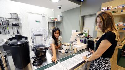 Harshita Mathur takes the order of a customer. The new eatery is located in the clubhouse of Rihan Heights in Abu Dhabi. Chris Whiteoak / The National