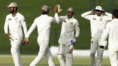 Saqlain Haider, centre, wicketkeeper for the UAE celebrates with teammates against Papua New Guinea during their Intercontinental Cup cricket match at Zayed Cricket Stadium in Abu Dhabi on April 9, 2017. Christopher Pike / The National