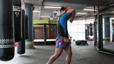 Begin at fighting position with the right hand guarding your chin. Jeffrey E Biteng / The National