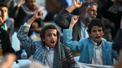 Yemeni Shiite supporters of the Houthi movement chant slogans before dismantling part of their protest camp in Sanaa on October 16. Mohammed Huwais / AFP