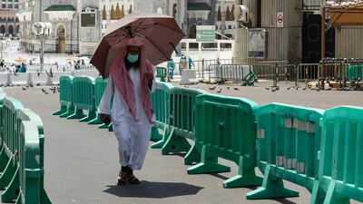 A man carries an umbrella to protect himself from the sun in Makkah. AFP