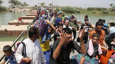 Iraqis from Ramadi cross the Bzebiz bridge in a bid to flee fighting in the Iraqi city 65km west of Baghdad as ISIL takes control. Karim Kadim/AP Photo