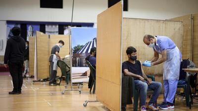 A man receives an injection at a vaccination centre in Baitul Futuh Mosque. UK finance minister Rishi Sunak has spent £352bn in emergency measures during the crisis. Reuters