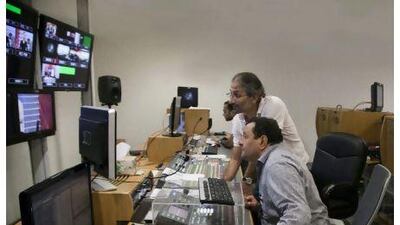 Omar Elkeddi (centre), chief news editor at Libya TV, works with his colleagues in the gallery. Credit: Raymond Bobar