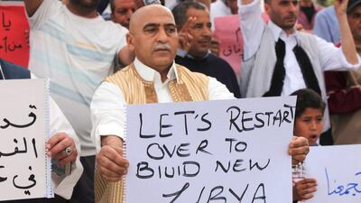 Supporters of Libya's unity government hold signs during a demonstration at Martyrs' Square in Tripoli on April 1, 2016. Hani Amara / Reuters