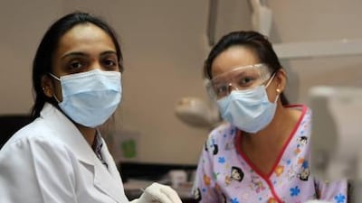 Dr. Bhagyashree Aditya Namjoshi treats a patient at Taj Dental Centre in Abu Dhabi. Dentists say parents take their children for care only when they are in pain - when the damage has already been done.