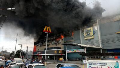 Smoke billows from a shopping mall on fire in Davao City, the Philippines. Yas D. Ocampo / via Reuters
