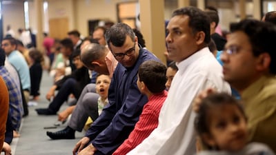 Muhammad Ali speaks to his son Murtaza, 9, before the start of prayer at the Muslim Community Association in Santa Clara.