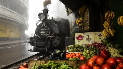 A Darjeeling Himalayan Railway steam train passes by a market in Ghum, India. All photos by Reuters