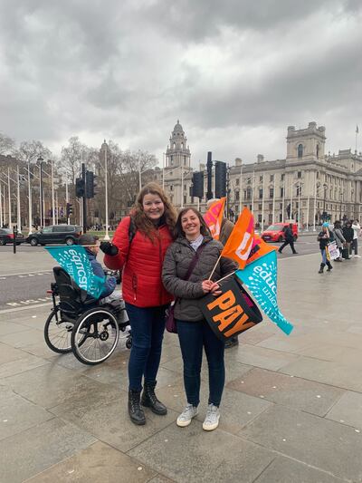 Striking teachers Rachel Claughan and Lisa Laverick pose with flags in Parliament Square, Westminster, following a protest. The National