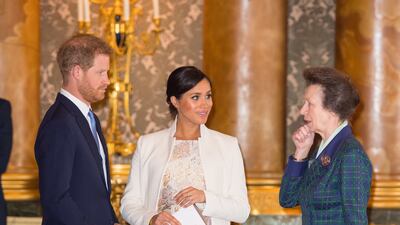 Prince Harry, Meghan, Duchess of Sussex, and Princess Anne attend a reception to mark the 50th anniversary of the investiture of the Prince of Wales at Buckingham Palace in 2019.