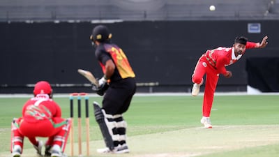 Nestor Dhamba of Oman bowls against Papua New Guinea.