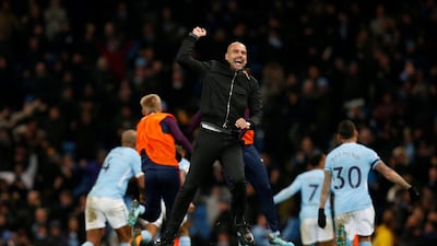 Pep Guardiola celebrates on the pitch after Raheem Sterling's last-gasp goal earns Manchester City and record-extending win. Andrew Yates / Reuters