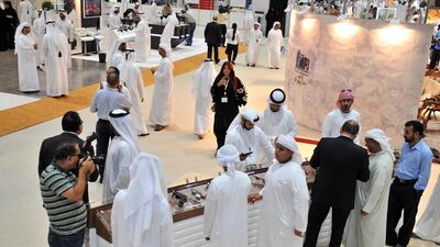 Visitors look at hand guns. Courtesy Adihex