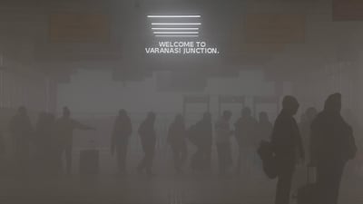 Passengers enter a railway station in dense smog on a winter morning in Varanasi, Uttar Pradesh state. AFP