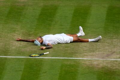 Australia's Nick Kyrgios lies on the ground after defeating Chile's Cristian Garin in their quarter-final on July 6, 2022. AP