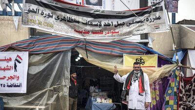 Dr Al Abadi stands outside his makeshift clinic in Tahrir Square. Luke Pierce for The National