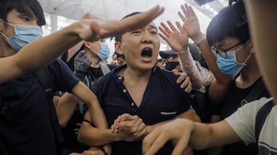 Protesters detain a man, who they claimed was a Chinese undercover agent during a demonstration at the airport in Hong Kong. AP Photo